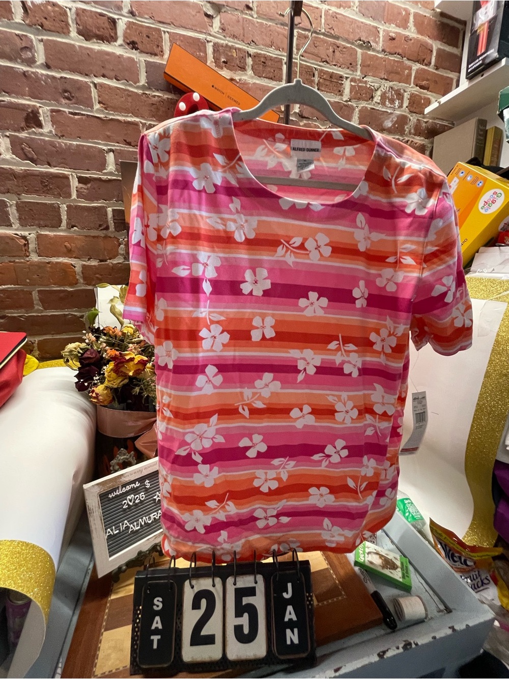 Alfred Dunner top features a vibrant pink and orange striped pattern decorated w